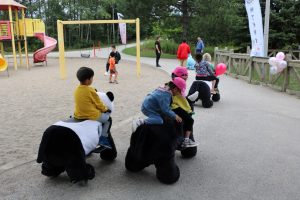 A group of people sitting at a park Description automatically generated